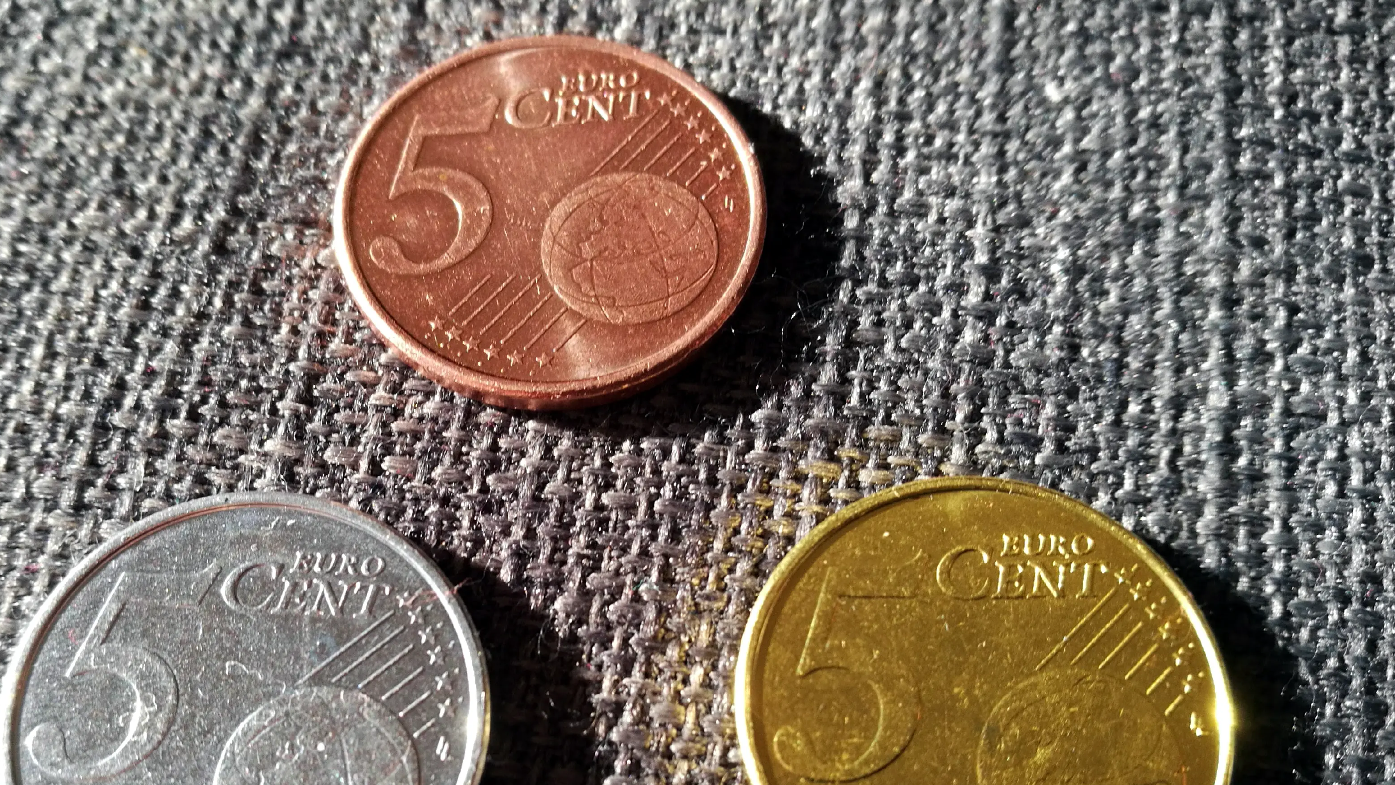 "Silver" and "gold" coating a 5 cent coin